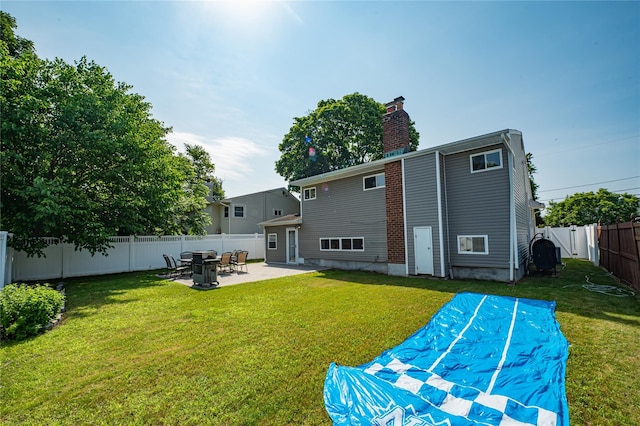 17 Abbott St, West Babylon, NY 11704 - rear view of property with a patio area, a fenced backyard, and a chimney