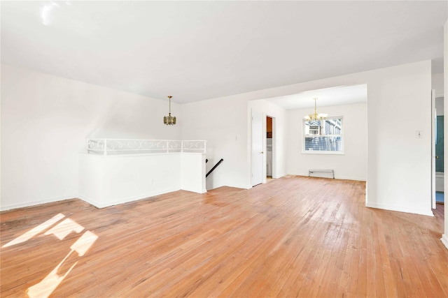 22401 Hillside Ave Unit 2, Queens Village, NY 11427 - unfurnished room featuring a chandelier and light wood-type flooring