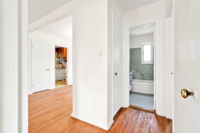 22401 Hillside Ave Unit 2, Queens Village, NY 11427 - corridor featuring light wood finished floors and baseboards
