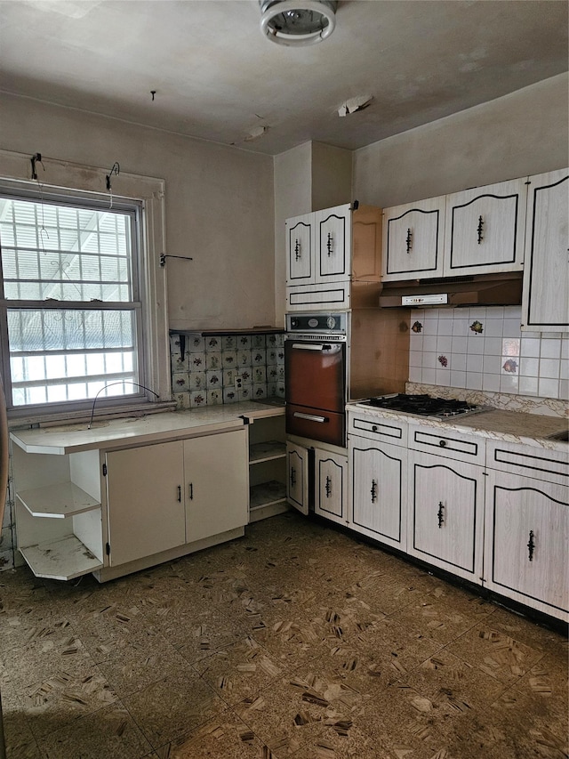 8931 184th St, Hollis, NY 11423 - kitchen featuring oven, open shelves, light countertops, tasteful backsplash, and stainless steel gas cooktop