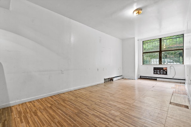 718 Garden St, Bronx, NY 10457 - unfurnished room featuring a baseboard heating unit and wood finished floors