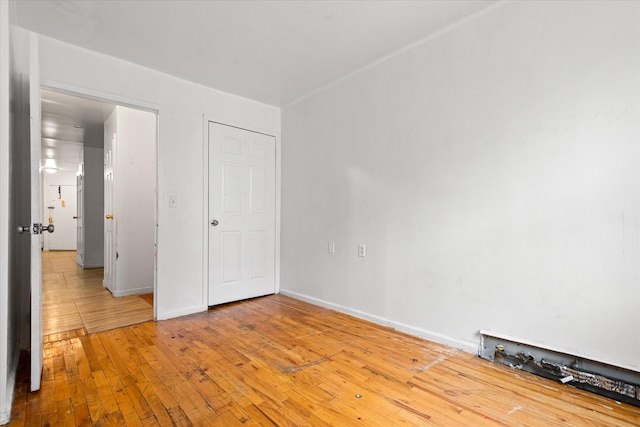 718 Garden St, Bronx, NY 10457 - unfurnished bedroom featuring baseboards and light wood-style floors