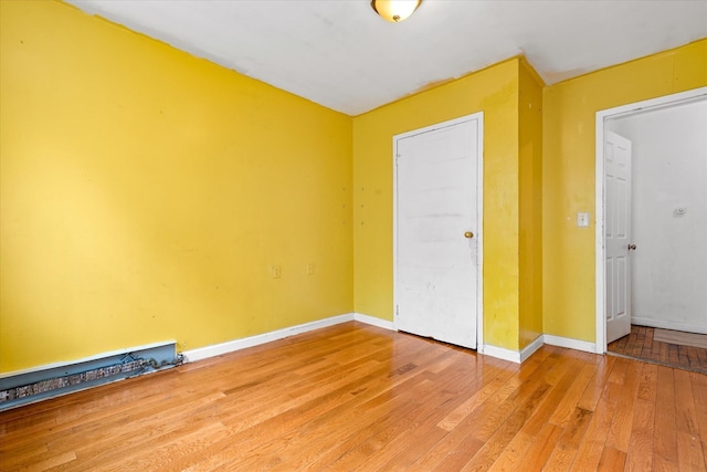 718 Garden St, Bronx, NY 10457 - unfurnished bedroom with light wood-style flooring and baseboards