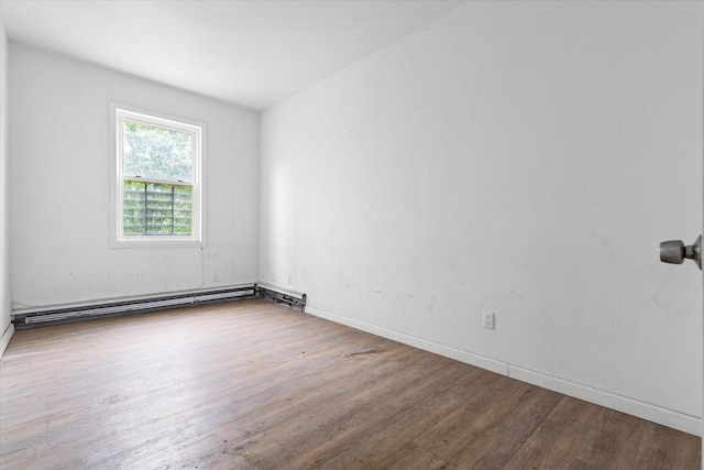 718 Garden St, Bronx, NY 10457 - spare room featuring wood finished floors and a baseboard radiator