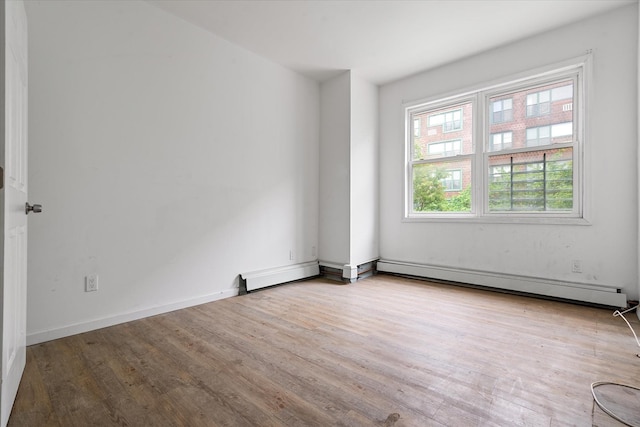 718 Garden St, Bronx, NY 10457 - unfurnished room with wood finished floors and baseboard heating