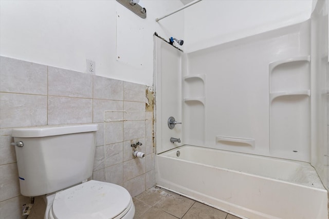 718 Garden St, Bronx, NY 10457 - bathroom with tile walls, shower / washtub combination, and tile patterned flooring
