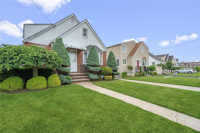 662 Benris Ave, Franklin Square, NY 11010 - view of front of home with brick siding, a front lawn, and a residential view