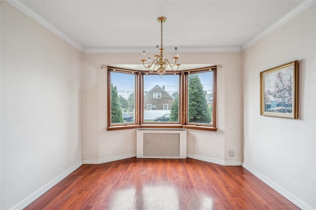 662 Benris Ave, Franklin Square, NY 11010 - spare room with radiator, a chandelier, wood finished floors, and crown molding
