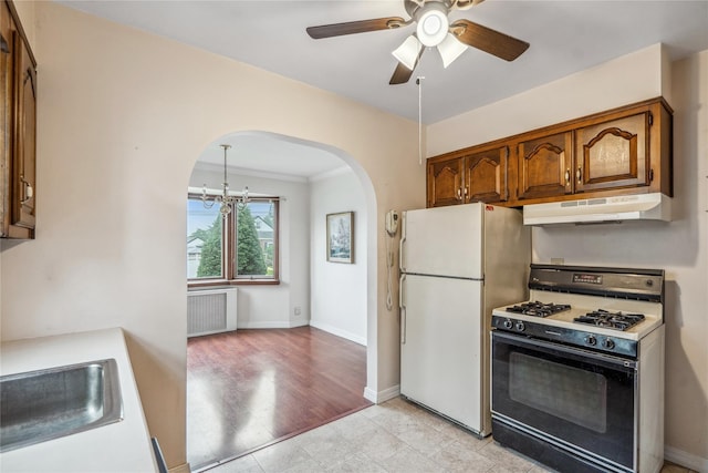 662 Benris Ave, Franklin Square, NY 11010 - kitchen with range with gas stovetop, freestanding refrigerator, under cabinet range hood, arched walkways, and radiator