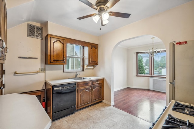 662 Benris Ave, Franklin Square, NY 11010 - kitchen featuring black dishwasher, freestanding refrigerator, radiator heating unit, arched walkways, and light countertops