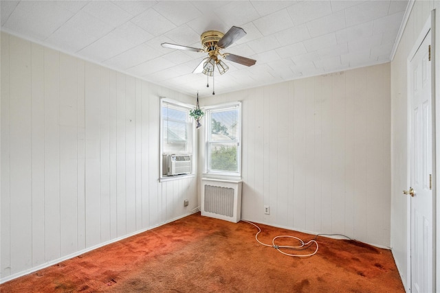 662 Benris Ave, Franklin Square, NY 11010 - carpeted spare room featuring cooling unit, a ceiling fan, radiator heating unit, and wood walls