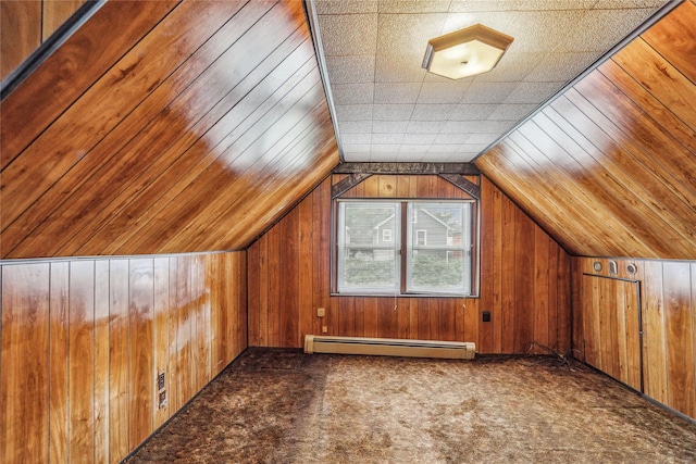 662 Benris Ave, Franklin Square, NY 11010 - additional living space with baseboard heating, wood walls, lofted ceiling, and carpet floors