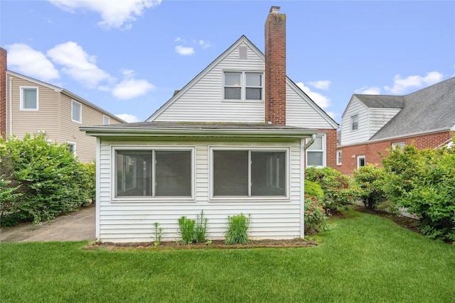 662 Benris Ave, Franklin Square, NY 11010 - back of property with a lawn and a chimney
