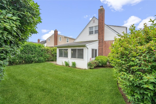 662 Benris Ave, Franklin Square, NY 11010 - rear view of property featuring a yard and a chimney