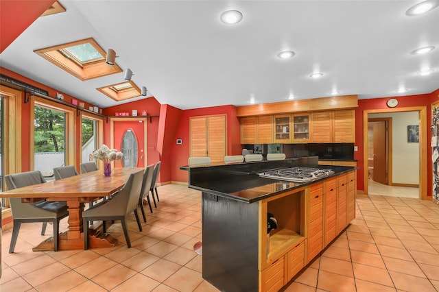 295 N Salem Rd, Waccabuc, NY 10597 - kitchen with stainless steel gas stovetop, dark countertops, recessed lighting, light tile patterned floors, and glass insert cabinets