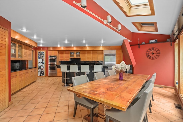 295 N Salem Rd, Waccabuc, NY 10597 - dining space featuring light tile patterned floors, a skylight, recessed lighting, and lofted ceiling