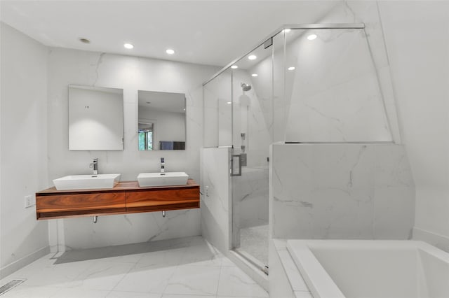295 N Salem Rd, Waccabuc, NY 10597 - bathroom with marble tiled floors, a bath, recessed lighting, double vanity, and a marble finish shower