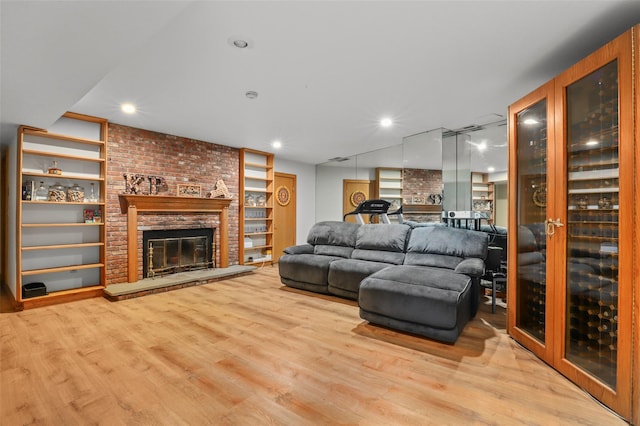 295 N Salem Rd, Waccabuc, NY 10597 - living room featuring wood finished floors, a fireplace, recessed lighting, and built in features