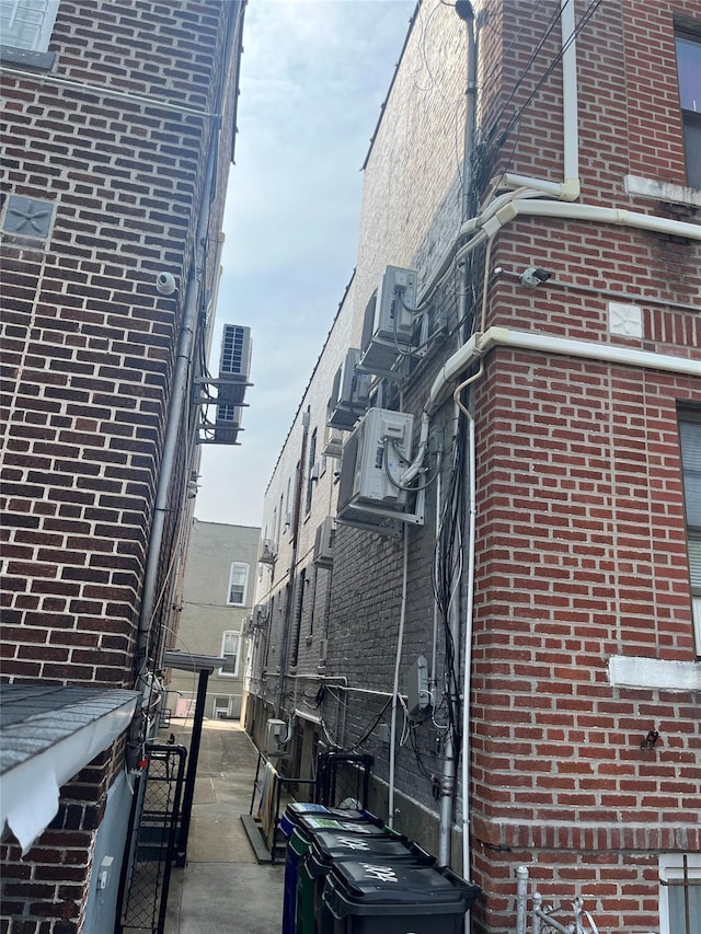 1004 Rhinelander Ave, Bronx, NY 10462 - view of side of home with brick siding and a central air condition unit