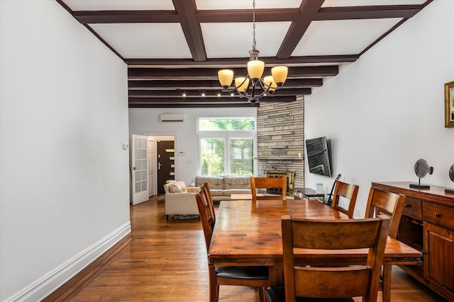 88-37 74th Ave, Glendale, NY 11385 - dining space with a chandelier, a wall mounted AC, wood finished floors, beamed ceiling, and a stone fireplace