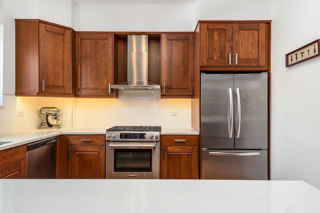 88-37 74th Ave, Glendale, NY 11385 - kitchen featuring appliances with stainless steel finishes, wall chimney exhaust hood, light countertops, and brown cabinets