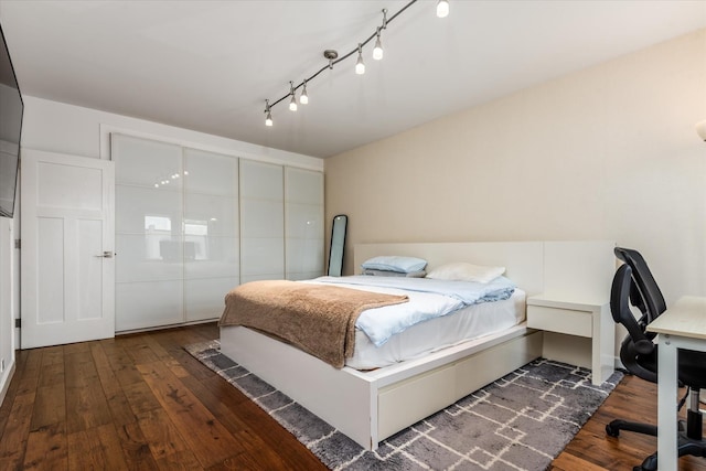 88-37 74th Ave, Glendale, NY 11385 - bedroom with wood-type flooring, a desk, and rail lighting