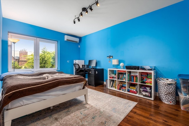 88-37 74th Ave, Glendale, NY 11385 - bedroom featuring a wall mounted air conditioner, wood finished floors, and rail lighting