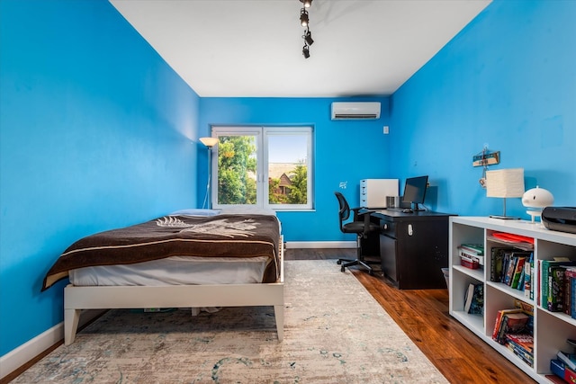 88-37 74th Ave, Glendale, NY 11385 - bedroom featuring an AC wall unit and wood finished floors