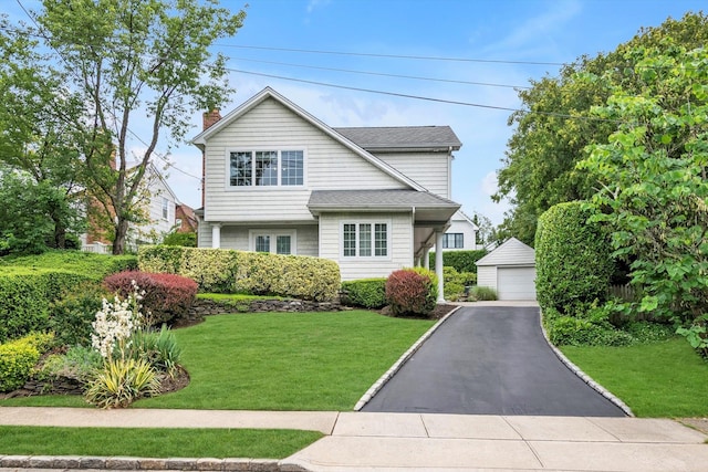 51 Highfield Ave, Port Washington, NY 11050 - traditional home with an outdoor structure, a detached garage, a front yard, and a chimney