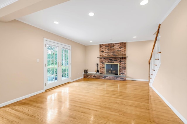 51 Highfield Ave, Port Washington, NY 11050 - unfurnished living room with stairway, light wood-style floors, crown molding, a brick fireplace, and recessed lighting