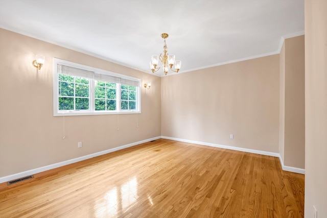 51 Highfield Ave, Port Washington, NY 11050 - spare room with a chandelier, ornamental molding, and light wood-type flooring