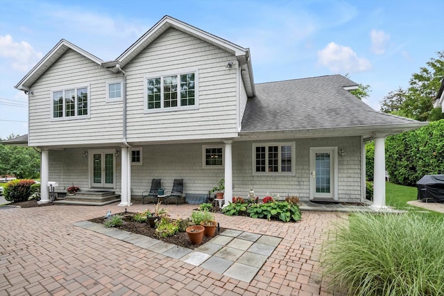51 Highfield Ave, Port Washington, NY 11050 - back of house with french doors, a patio area, and roof with shingles