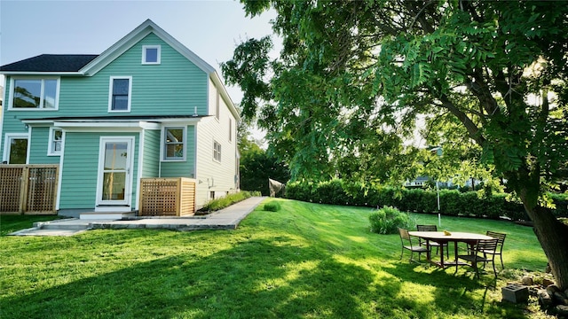 412 Atlantic Ave, Greenport, NY 11944 - back of house featuring a lawn
