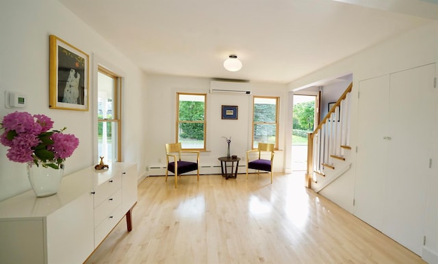 412 Atlantic Ave, Greenport, NY 11944 - foyer entrance featuring light wood-style floors, stairs, a wall unit AC, and a baseboard radiator