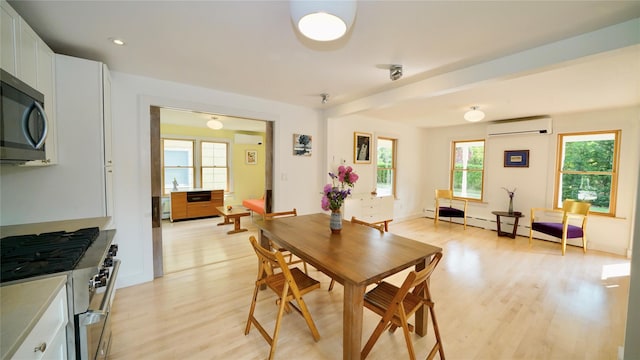 412 Atlantic Ave, Greenport, NY 11944 - dining space with an AC wall unit, light wood-style flooring, plenty of natural light, and baseboard heating