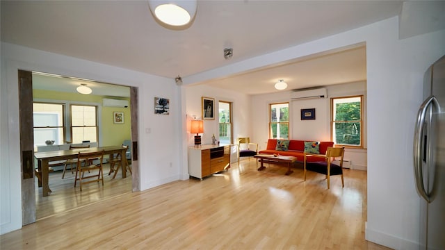 412 Atlantic Ave, Greenport, NY 11944 - living area with a wall unit AC and light wood-type flooring