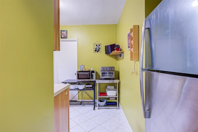 83-85 Woodhaven Blvd Unit 6F, Woodhaven, NY 11421 - kitchen with freestanding refrigerator, light tile patterned floors, and light countertops