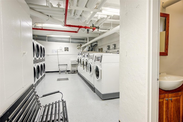 83-85 Woodhaven Blvd Unit 6F, Woodhaven, NY 11421 - shared laundry room with separate washer and dryer and a textured wall