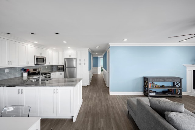 26 W Broadway Unit 405, Long Beach, NY 11561 - kitchen with appliances with stainless steel finishes, a peninsula, white cabinets, ornamental molding, and open floor plan