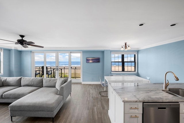 26 W Broadway Unit 405, Long Beach, NY 11561 - living area featuring ornamental molding, dark wood-style floors, a chandelier, and a ceiling fan