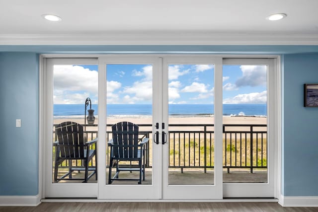 26 W Broadway Unit 405, Long Beach, NY 11561 - doorway to outside with view of water and beach, wood finished floors, plenty of natural light, ornamental molding, and recessed lighting