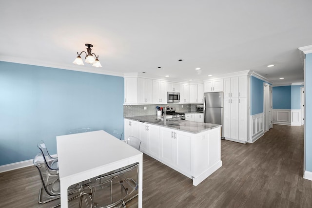 26 W Broadway Unit 405, Long Beach, NY 11561 - kitchen with stainless steel appliances, white cabinetry, recessed lighting, dark wood-style flooring, and a peninsula