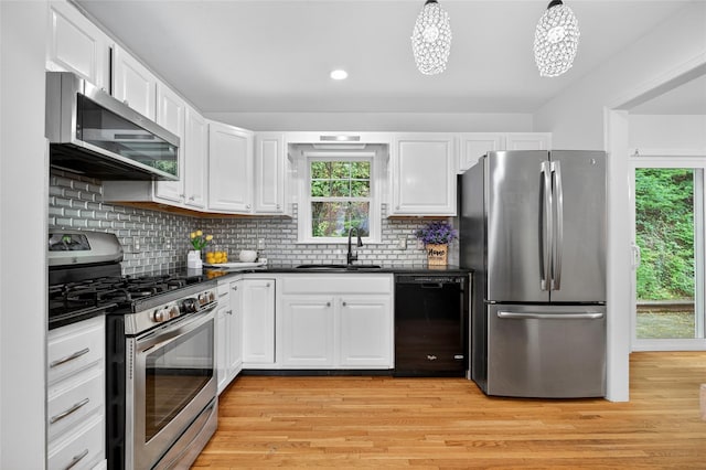 18 Jenkins Ct, Ossining, NY 10562 - kitchen with appliances with stainless steel finishes, dark countertops, white cabinetry, and recessed lighting