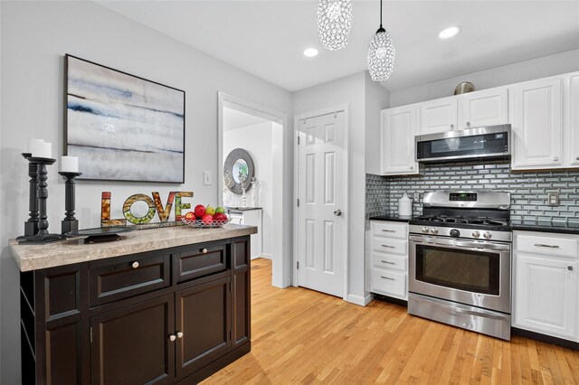 18 Jenkins Ct, Ossining, NY 10562 - kitchen with stainless steel appliances, white cabinetry, light wood-style floors, tasteful backsplash, and recessed lighting