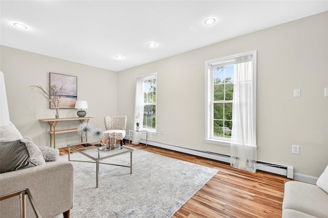 18 Jenkins Ct, Ossining, NY 10562 - living room with wood finished floors, a baseboard heating unit, and recessed lighting
