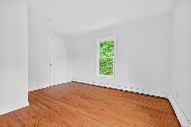 18 Jenkins Ct, Ossining, NY 10562 - empty room featuring baseboard heating, wood finished floors, and a smoke detector