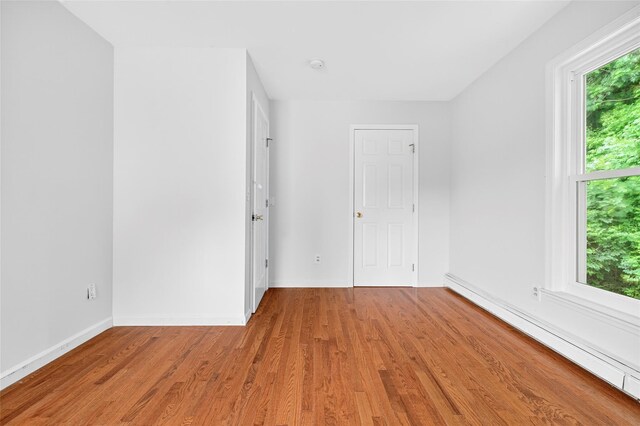 18 Jenkins Ct, Ossining, NY 10562 - spare room featuring a baseboard heating unit, light wood-style flooring, and a smoke detector