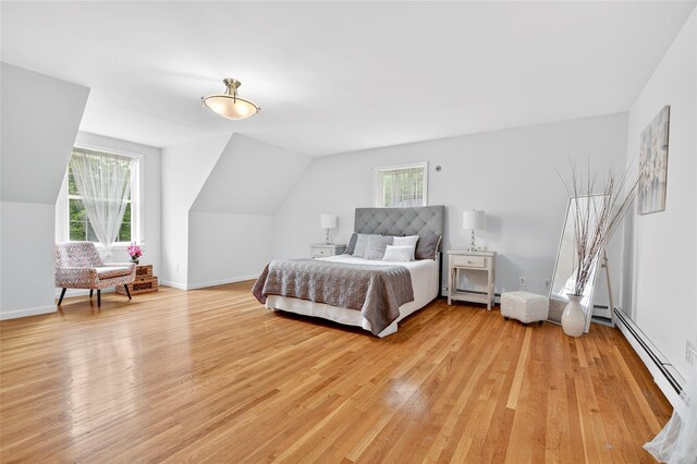18 Jenkins Ct, Ossining, NY 10562 - bedroom with light wood-style flooring, lofted ceiling, and a baseboard radiator
