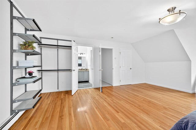18 Jenkins Ct, Ossining, NY 10562 - unfurnished bedroom featuring light wood-style flooring, lofted ceiling, and ensuite bath