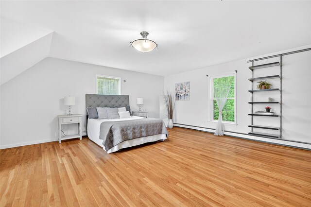 18 Jenkins Ct, Ossining, NY 10562 - bedroom with light wood-style floors, vaulted ceiling, and baseboard heating